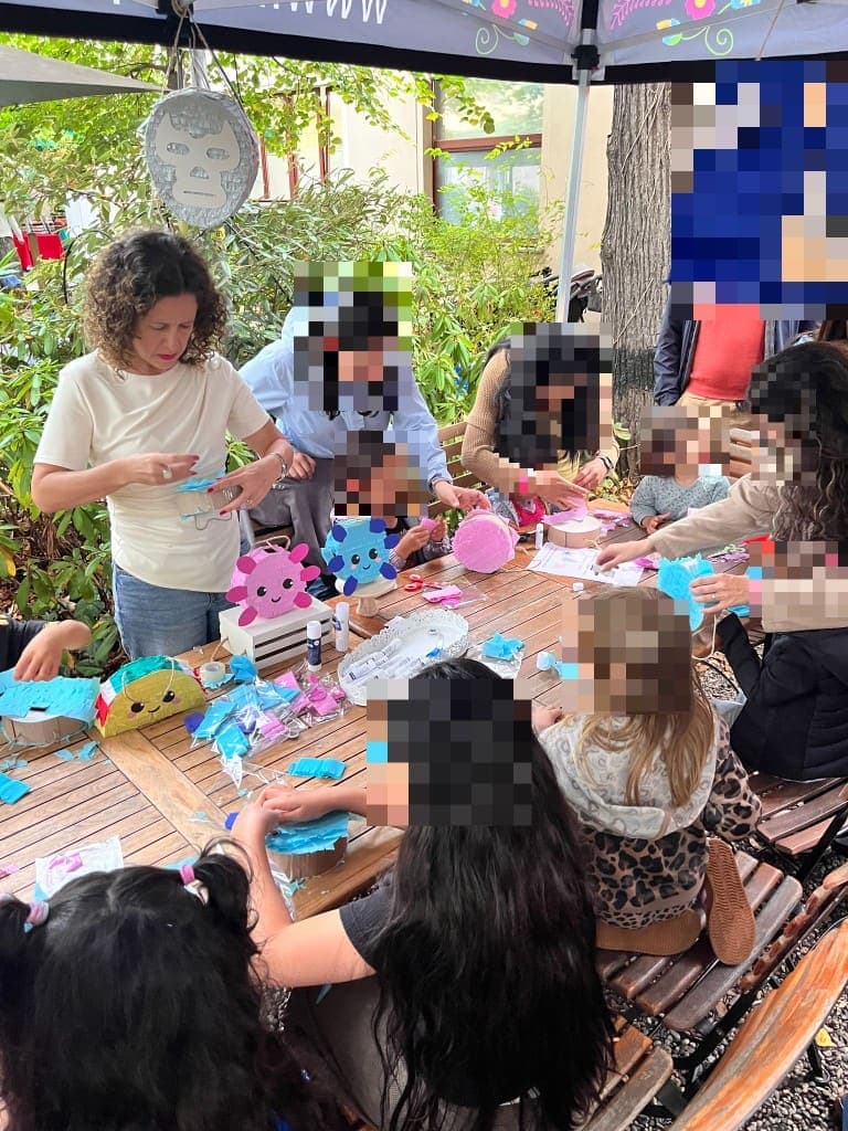 Piñata workshop in progress around a long table